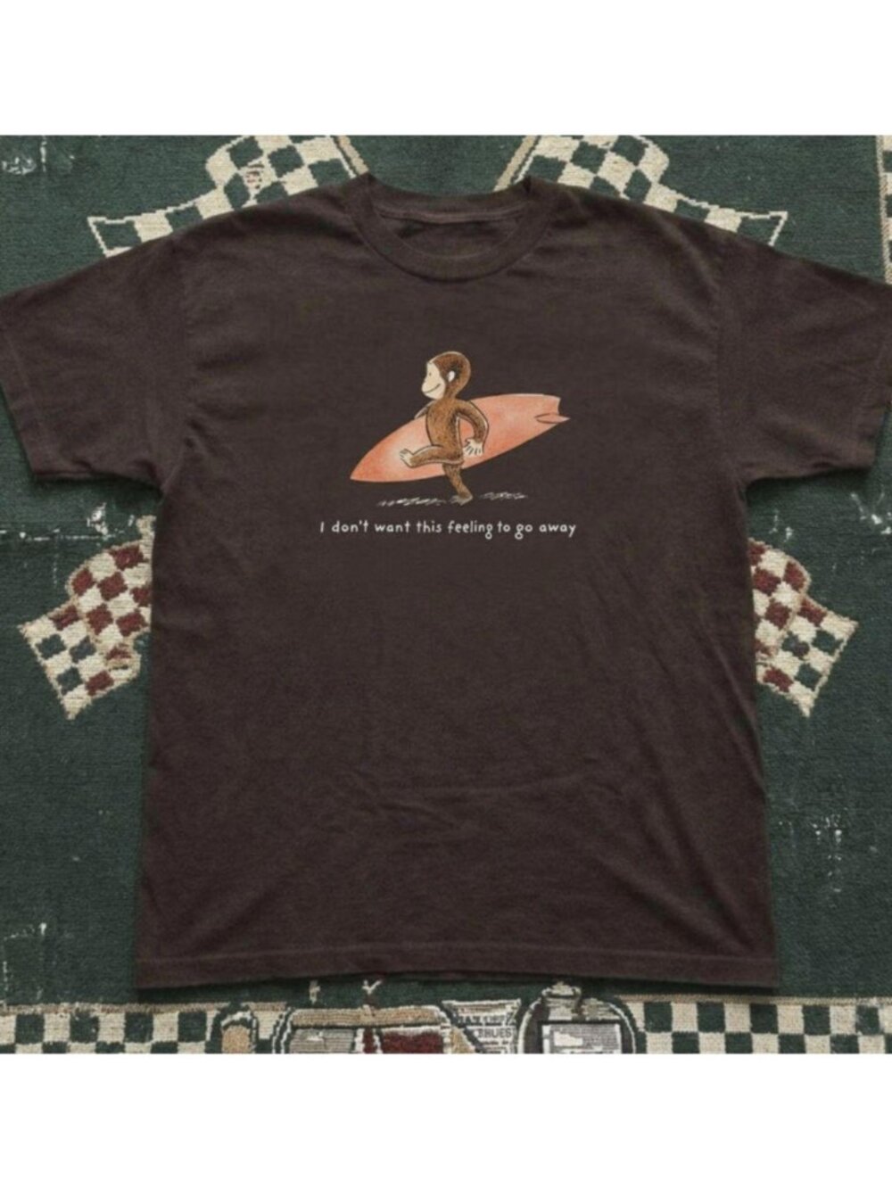 Brown Curious George monkey surfing